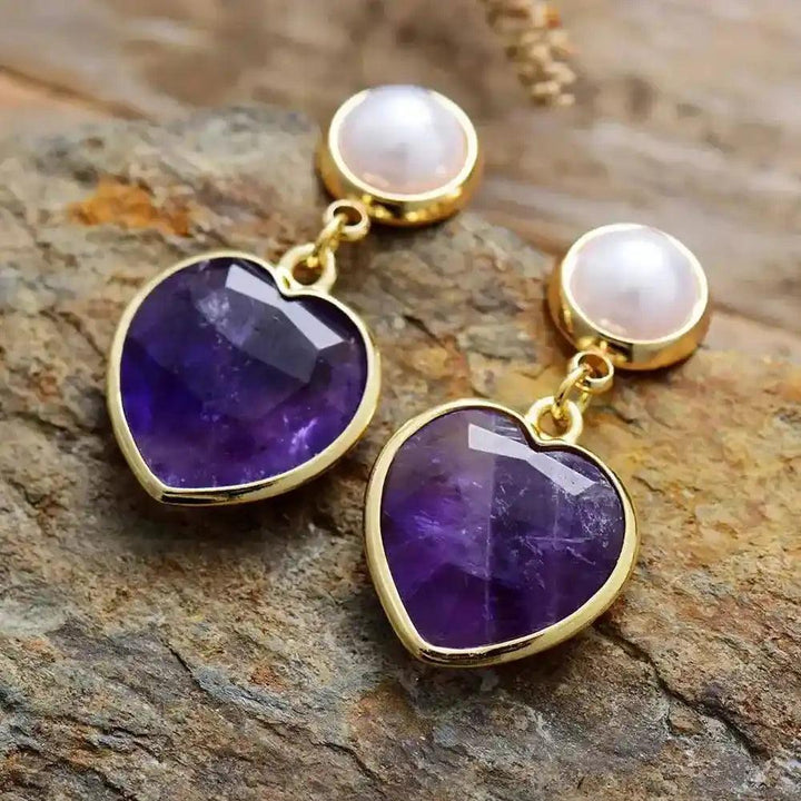 Elegant Amethyst Heart Stud Earrings with pearl tops, set in gold, for calm and spiritual clarity.