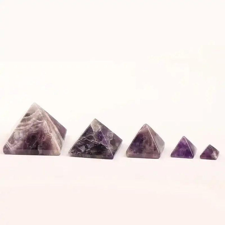 Hand-polished Amethyst Mini Pyramids in varying sizes, featuring rich purple hues and natural quartz patterns.