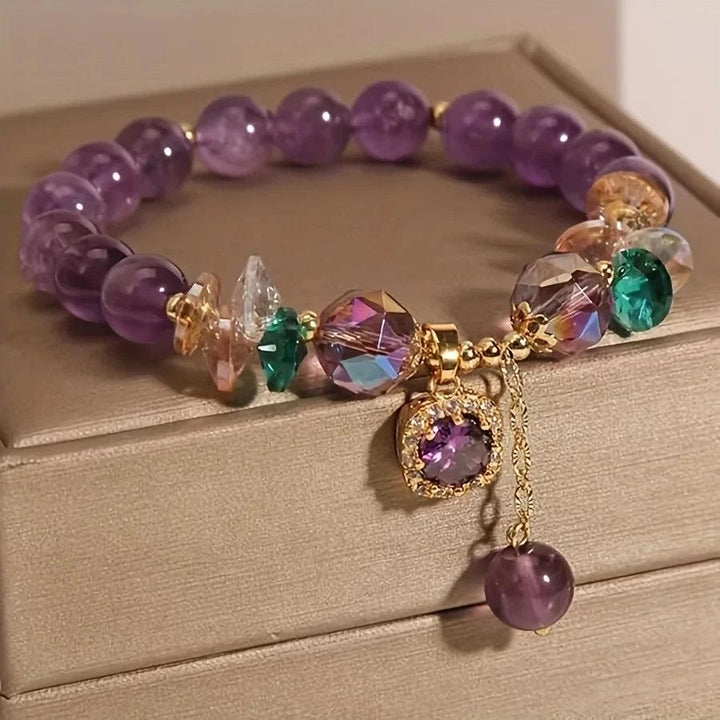 Amethyst Natural Stone Bead Bracelet for Calm and Healing, featuring deep purple beads, faceted crystals, and a gold charm.