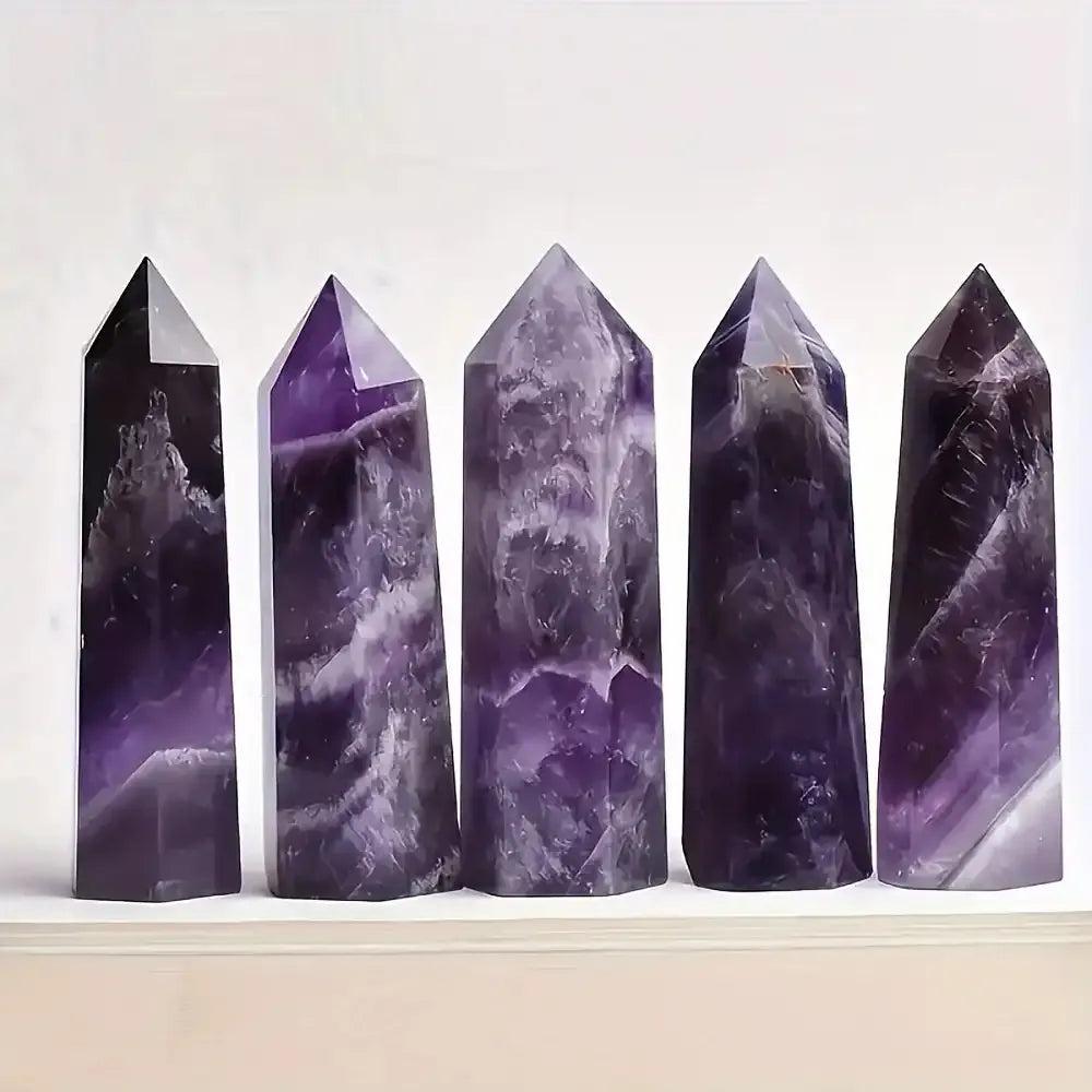 Polished amethyst towers featuring deep purple hues and pale veining, perfect for crown chakra meditation and reflection.