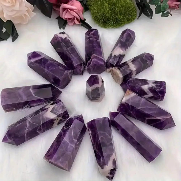 Polished amethyst towers with deep purple hues and pale veining, perfect for crown chakra meditation and spiritual focus.
