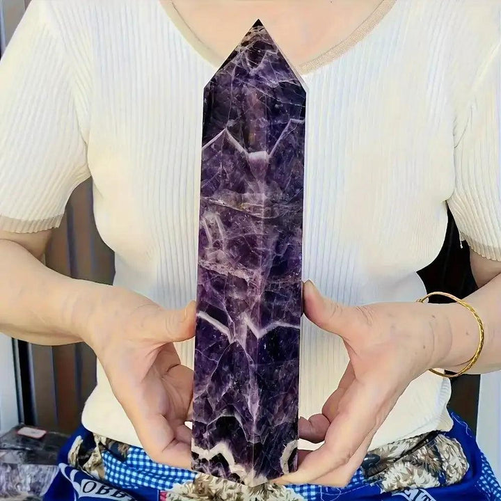Polished amethyst tower with deep purple hues and pale veining, perfect for crown chakra meditation and spiritual focus.