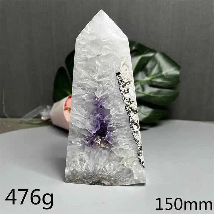 476g Amethyst and Quartz crystal geode tower with a polished pointed top, purple cavity, and unique dark mineral patches.