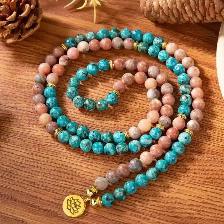 Vibrant 108 Beads Apatite Mala Bracelet-Necklace with blue and peach beads, gold accents, and a lotus charm for clarity.