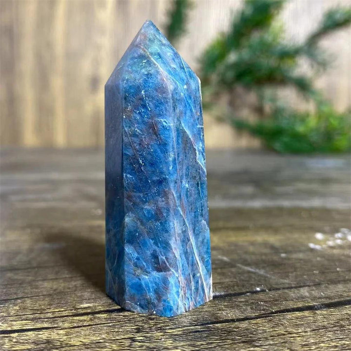 Natural blue apatite crystal tower wand for healing, featuring deep azure tones and a polished gemstone point.
