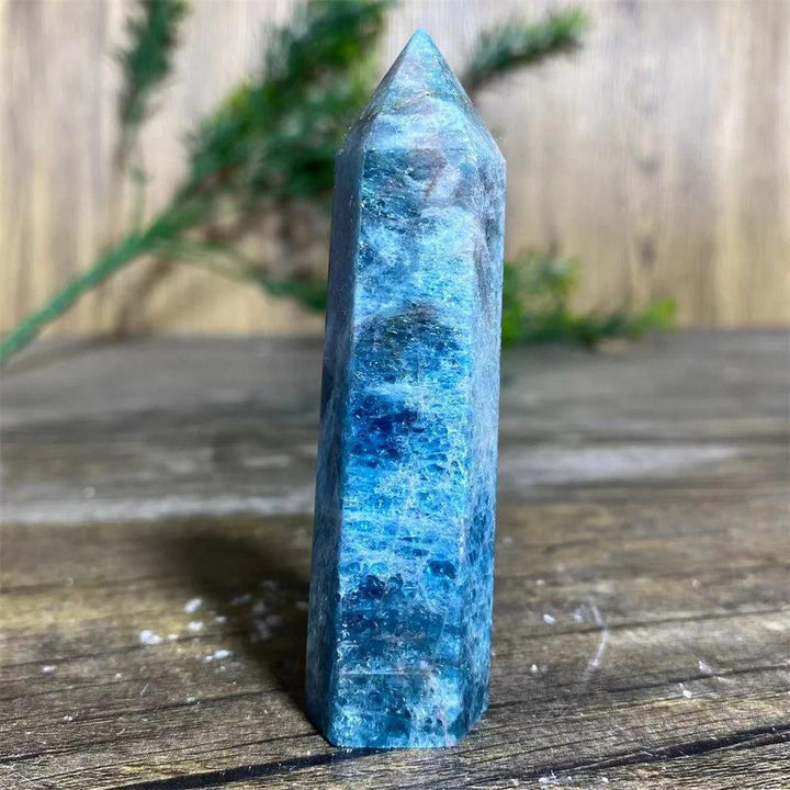Natural blue apatite crystal tower wand for healing, featuring a polished gemstone point with vibrant mineral textures.