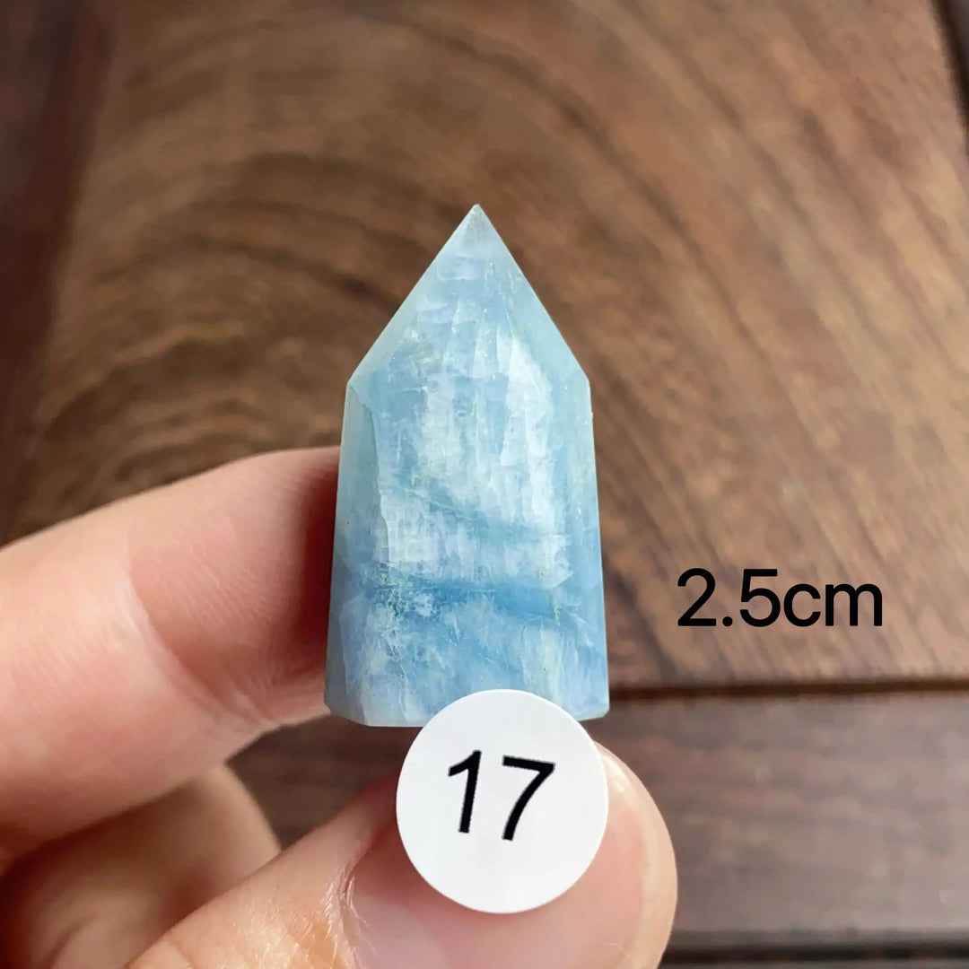 Hand-polished Aquamarine Mini Tower, piece 17, featuring a sea-blue faceted point for calm communication and energy.