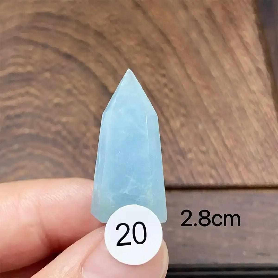 Small Aquamarine Mini Tower with a faceted point, featuring a calming sea-blue color for throat chakra healing.