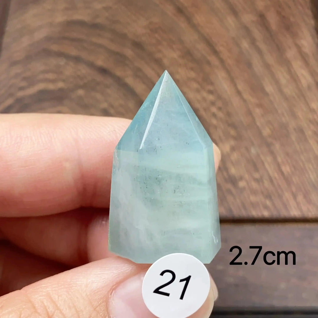Hand-polished Aquamarine Mini Tower, piece 21, featuring a sea-blue faceted point for calm communication and energy.