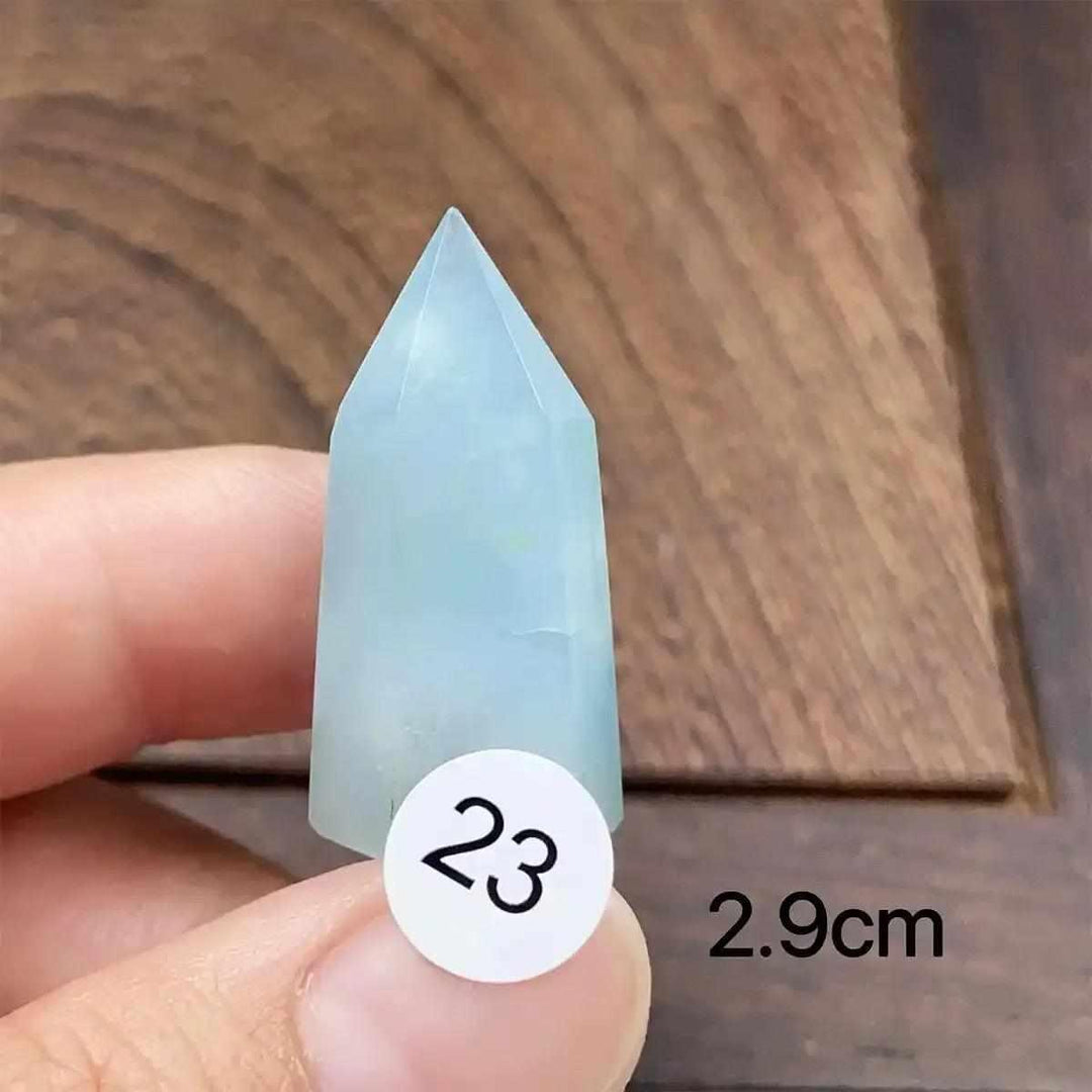 Small aquamarine mini tower with a faceted point, featuring calming sea-blue tones for Throat and Heart chakra healing.