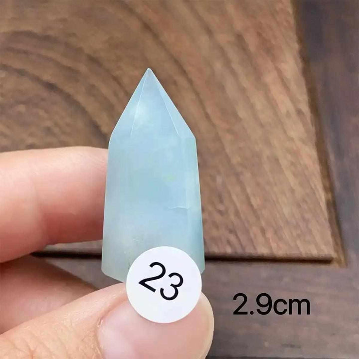Small aquamarine mini tower with a faceted point, featuring calming sea-blue tones for Throat and Heart chakra healing.