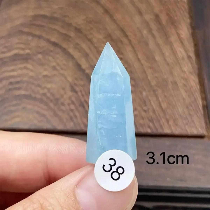 Hand-polished Aquamarine Mini Tower with a faceted point, showcasing serene blue tones for calm, clear communication.