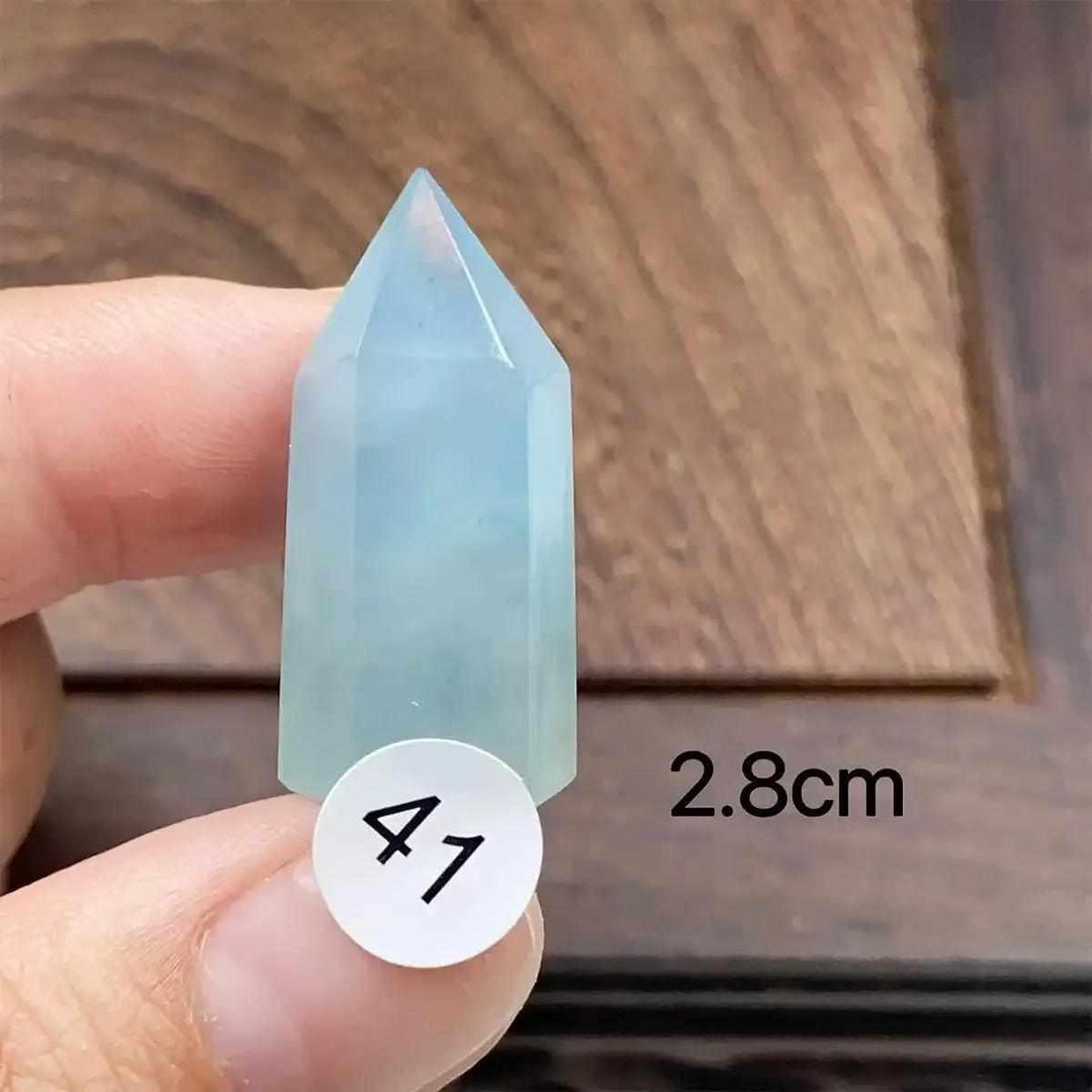 Small Aquamarine Mini Tower with a faceted point, featuring a calming sea-blue hue for throat chakra healing.
