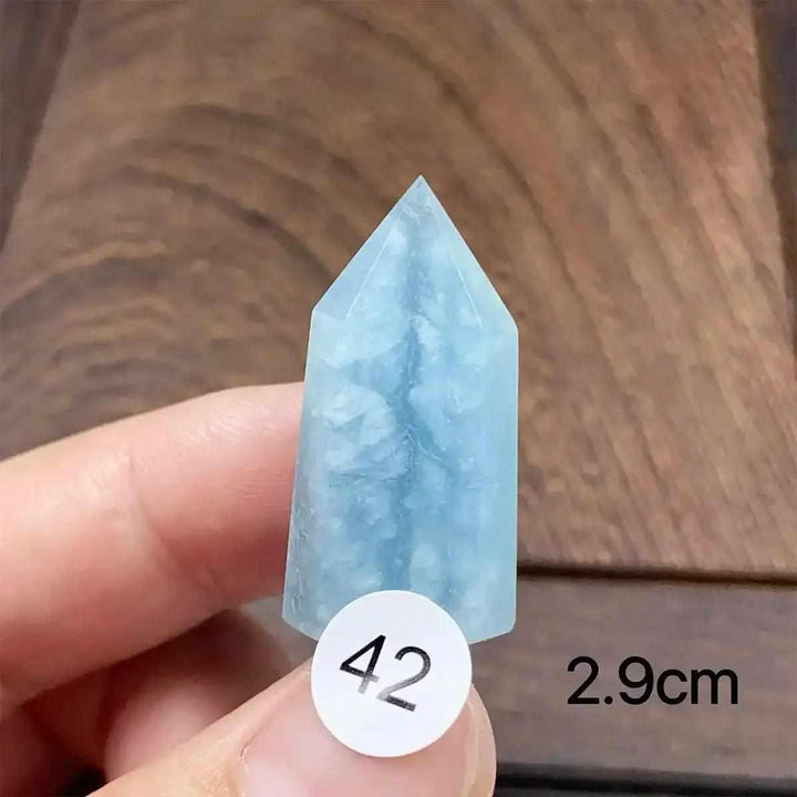 Hand-polished Aquamarine Mini Tower, piece 42, featuring a sea-blue faceted point for calm, clear communication.
