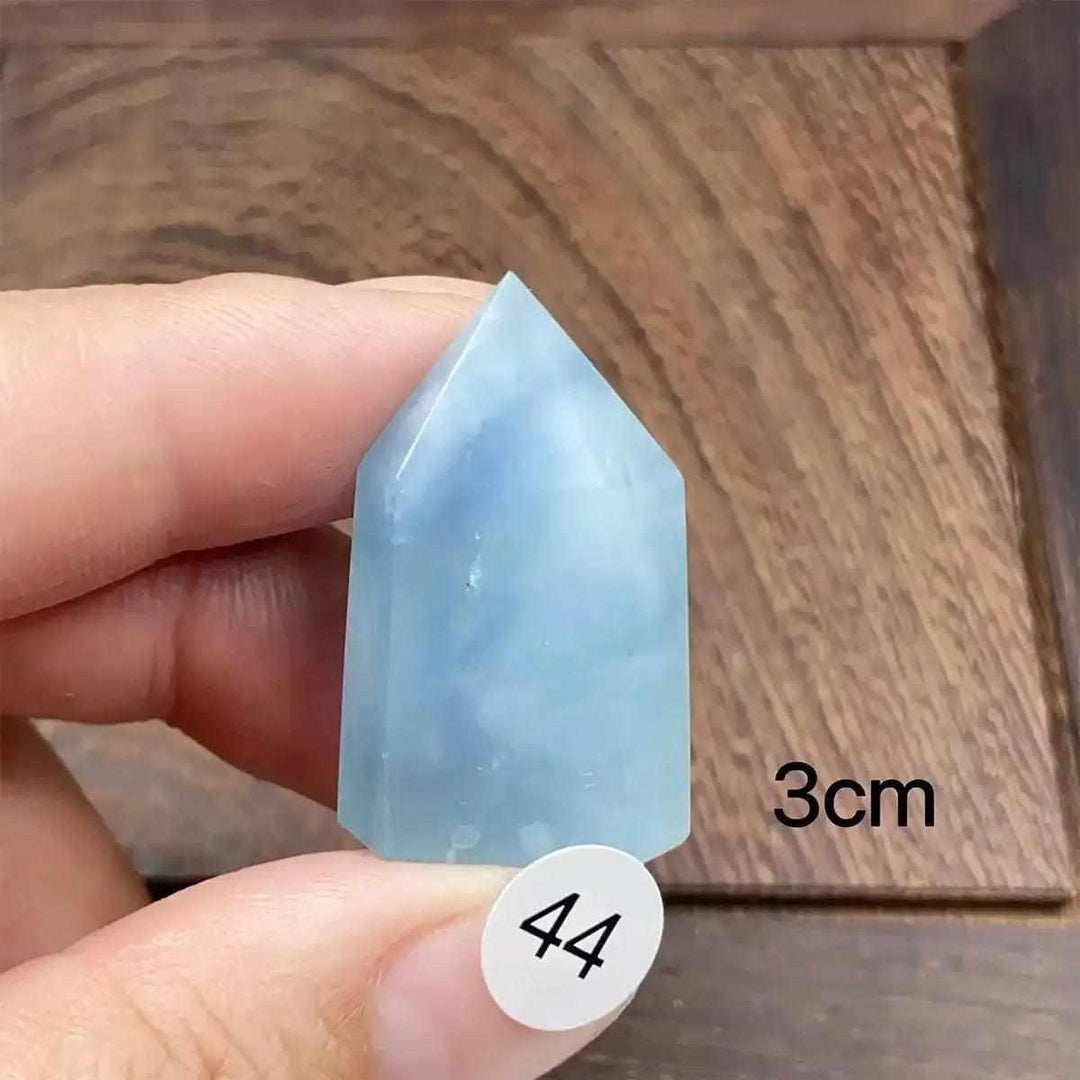 Hand-polished Aquamarine Mini Tower with a faceted point, featuring calming sea-blue tones for throat chakra healing.