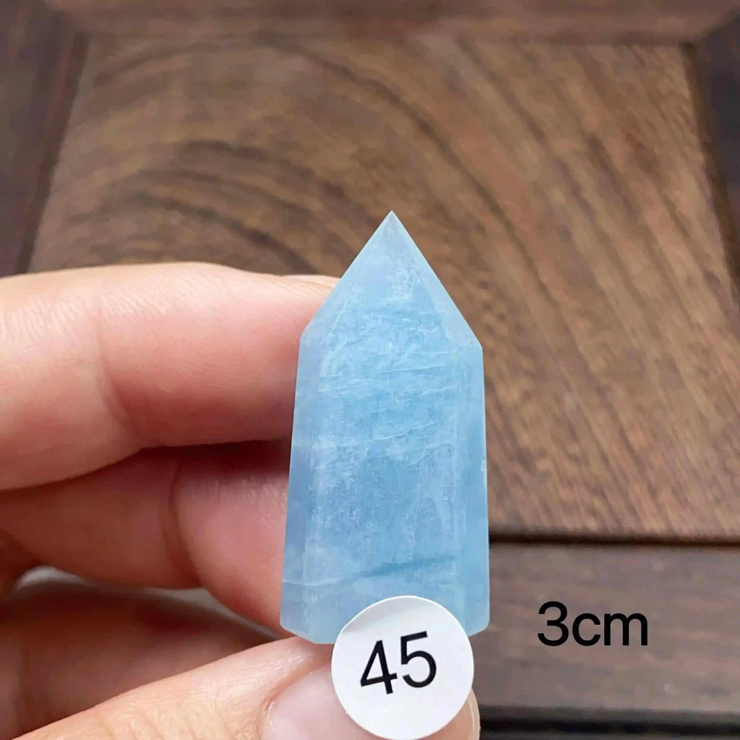 Small Aquamarine Mini Tower crystal with a faceted point, featuring calming sea-blue tones for Throat Chakra healing.