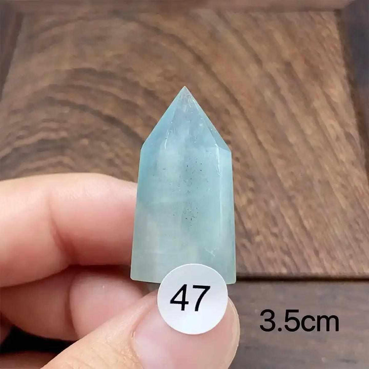 Hand-polished Aquamarine Mini Tower with a faceted point, featuring calming sea-blue tones for Throat Chakra healing.