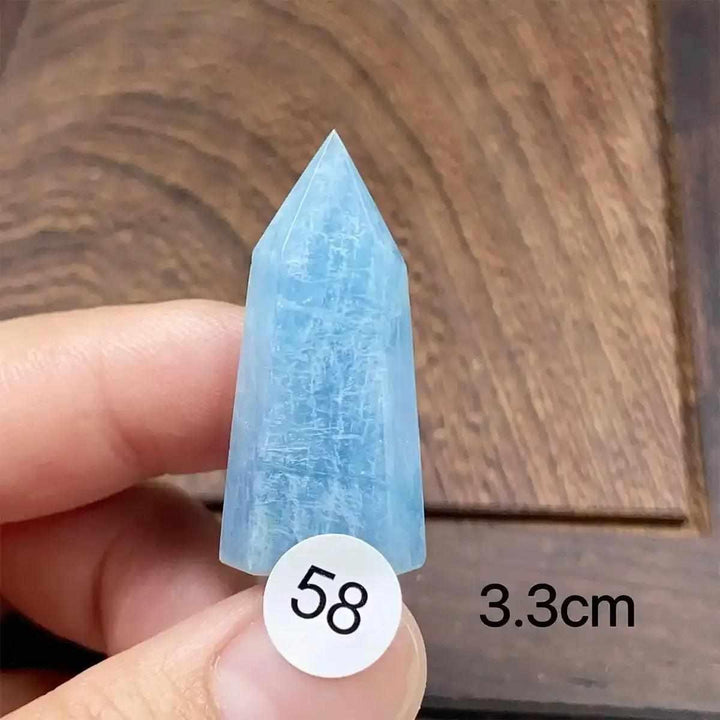 Hand-polished aquamarine mini tower with a faceted point, featuring calming sea-blue tones for meditation and healing.