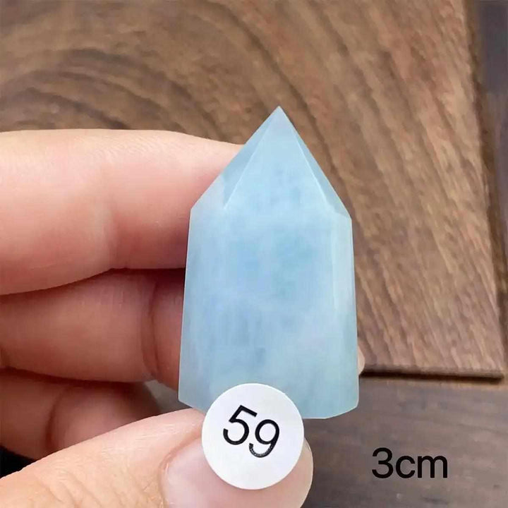 Hand-polished Aquamarine Mini Tower with a faceted point, featuring calming sea-blue tones for Throat Chakra healing.