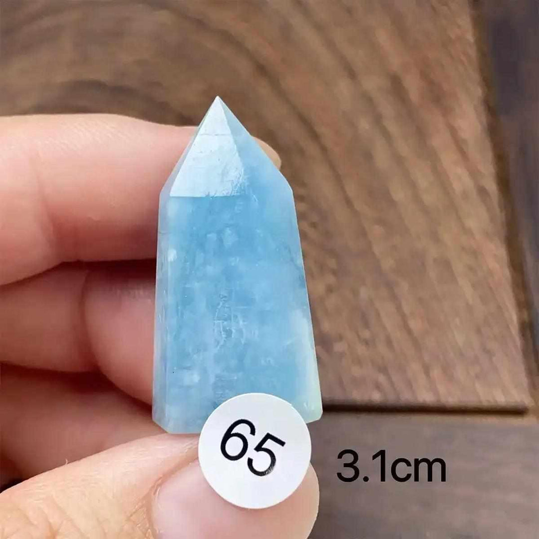 Hand-polished Aquamarine Mini Tower with sea-blue hues, faceted point, and natural inclusions for calm energy.