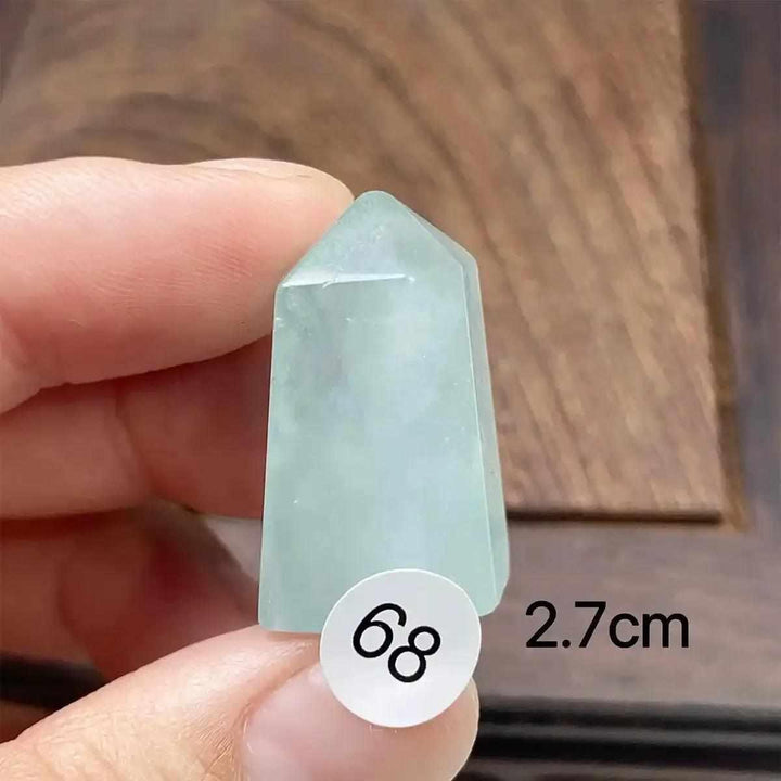 Hand-polished Aquamarine Mini Tower with a faceted point, featuring a calming sea-blue hue for Throat Chakra healing.