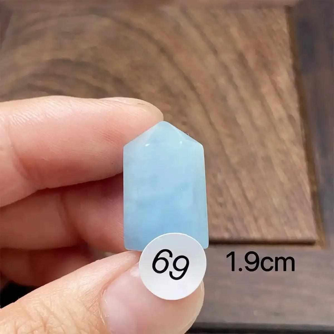 Small Aquamarine Mini Tower with a faceted point, featuring a calming sea-blue hue for throat chakra healing and focus.