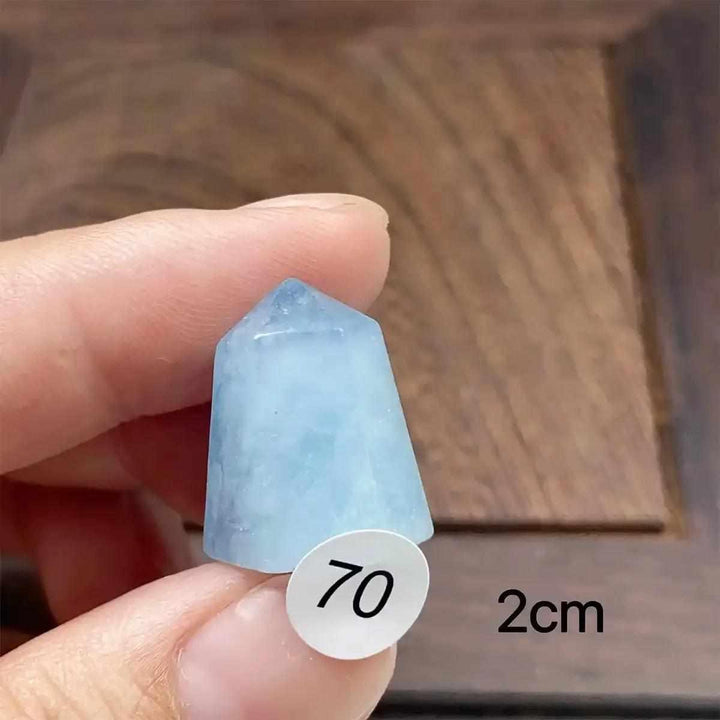 Small Aquamarine Mini Tower with a faceted point, featuring a calming sea-blue hue for throat chakra energy and healing.