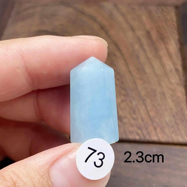 Small Aquamarine Mini Tower, piece 73, featuring a polished, sea-blue faceted point for calm, clear communication.