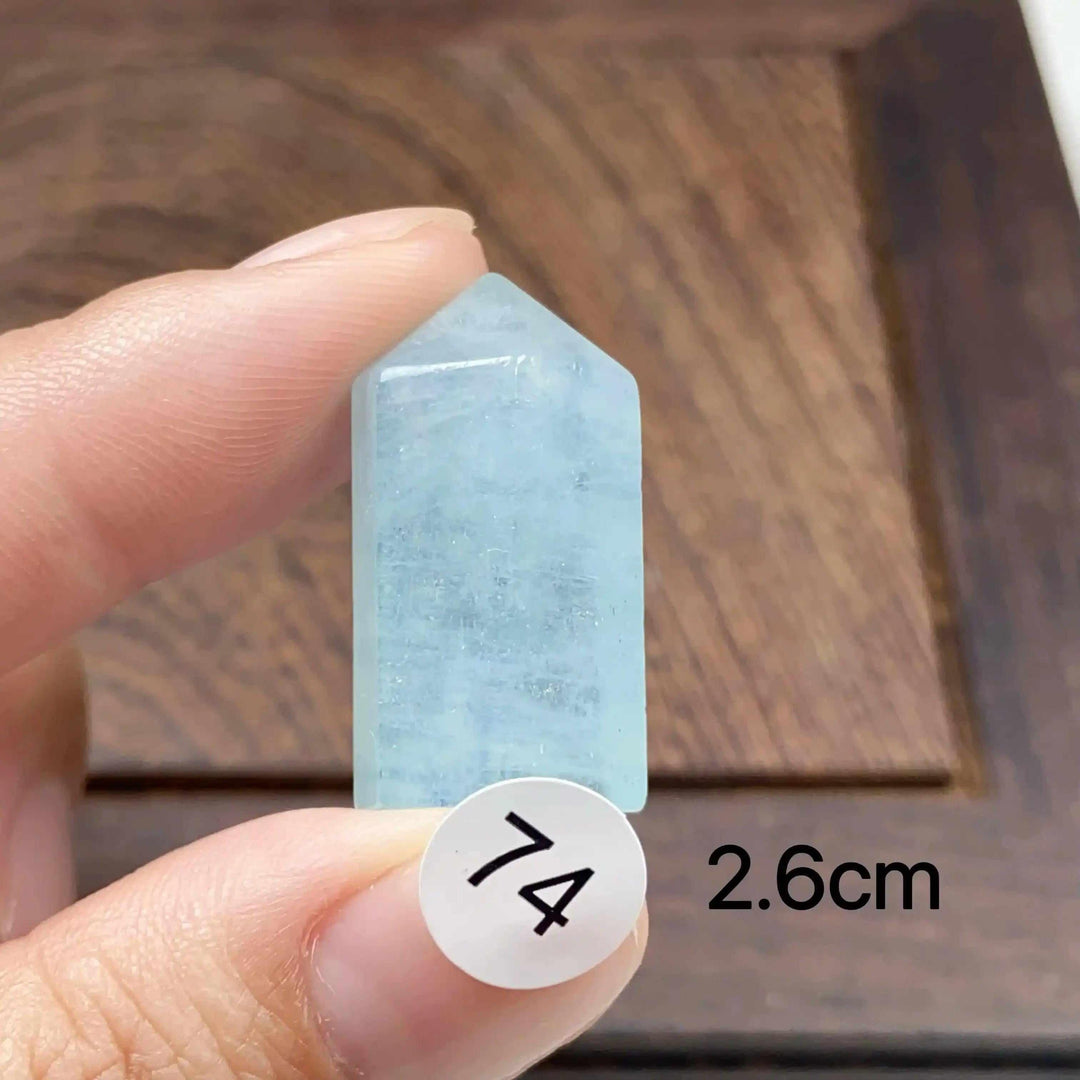 Hand-polished Aquamarine Mini Tower, piece 74, featuring a sea-blue faceted point for calm, clear communication.