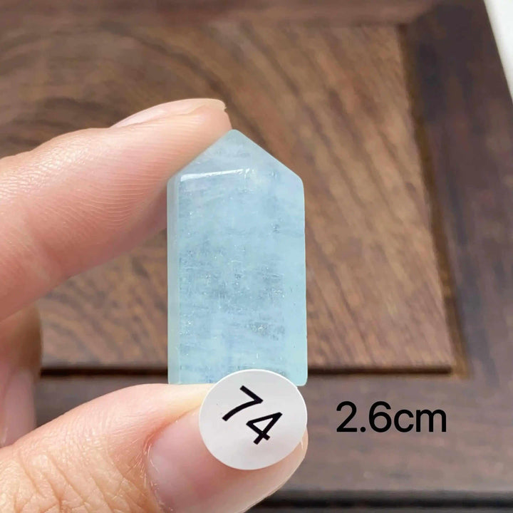 Hand-polished Aquamarine Mini Tower, piece 74, featuring a sea-blue faceted point for calm, clear communication.