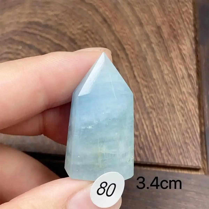 Hand-polished Aquamarine Mini Tower with a faceted point, featuring calming sea-blue tones for Throat Chakra healing.