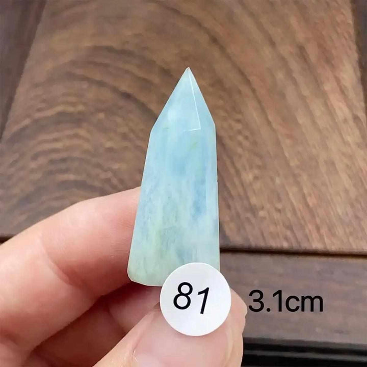 Hand-polished Aquamarine Mini Tower with a faceted point, featuring calming sea-blue tones for throat chakra healing.
