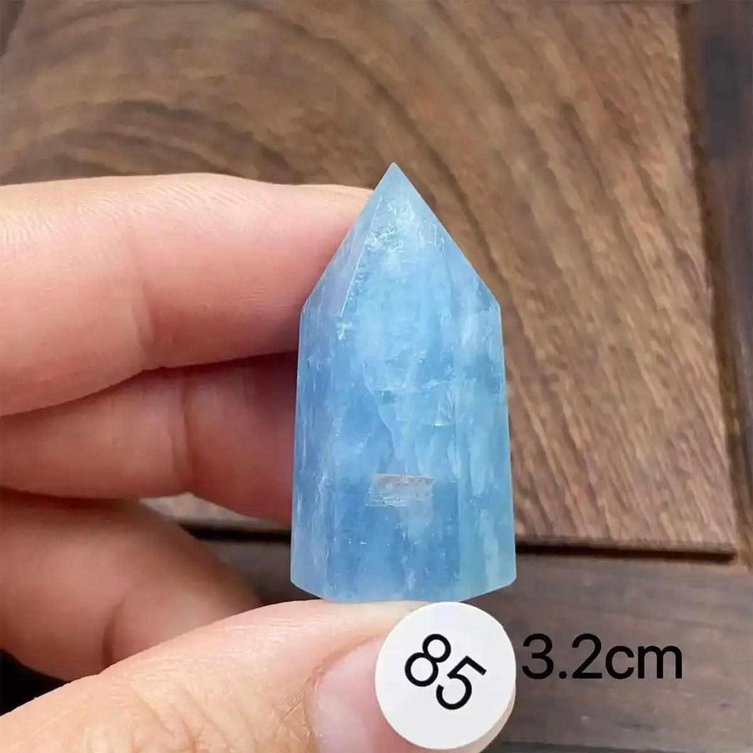 Hand-polished aquamarine mini tower with a faceted point, featuring calming sea-blue tones for meditation and healing.