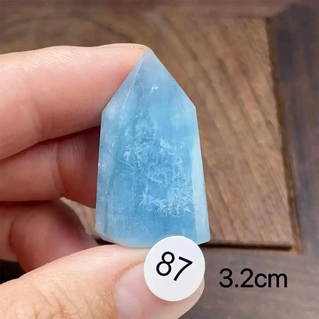 Hand-polished Aquamarine Mini Tower, piece 87, featuring a sea-blue faceted point for calm, clear communication.