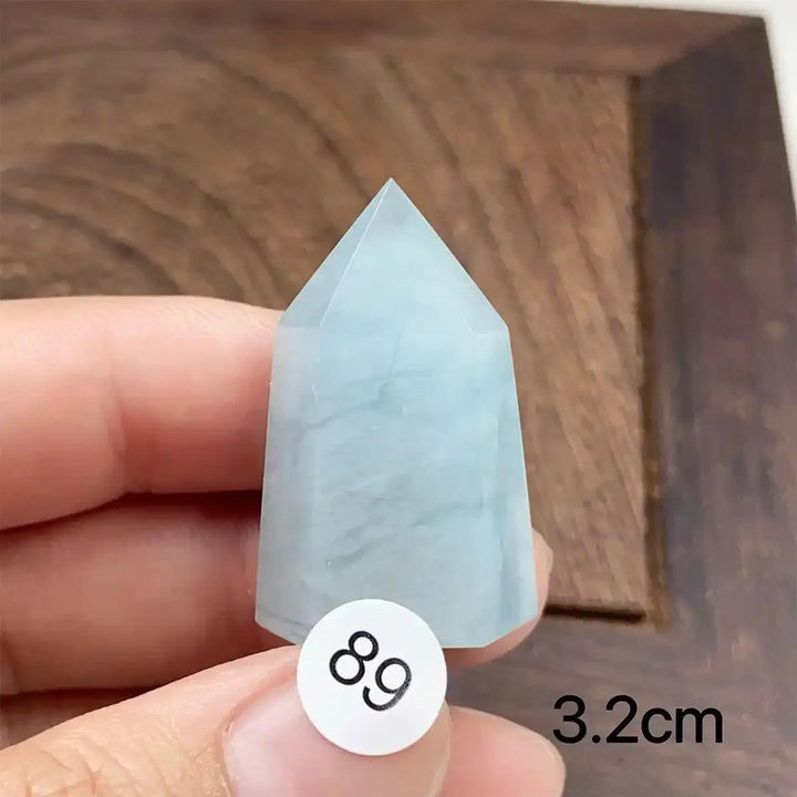 Hand-polished Aquamarine Mini Tower with a faceted point, featuring calming blue-green hues for Throat Chakra healing.