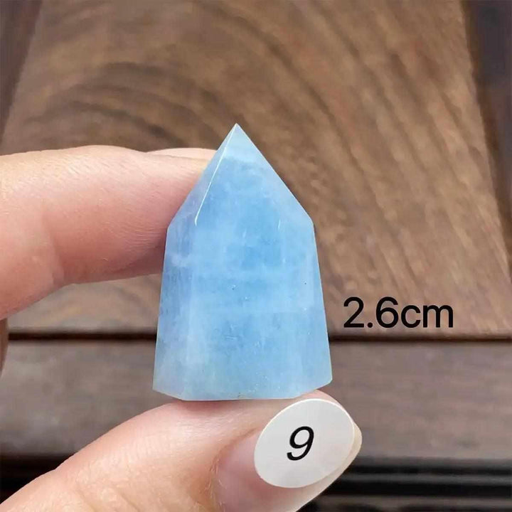 Hand-polished Aquamarine Mini Tower with a faceted point, showcasing a serene sea-blue color for calm communication.