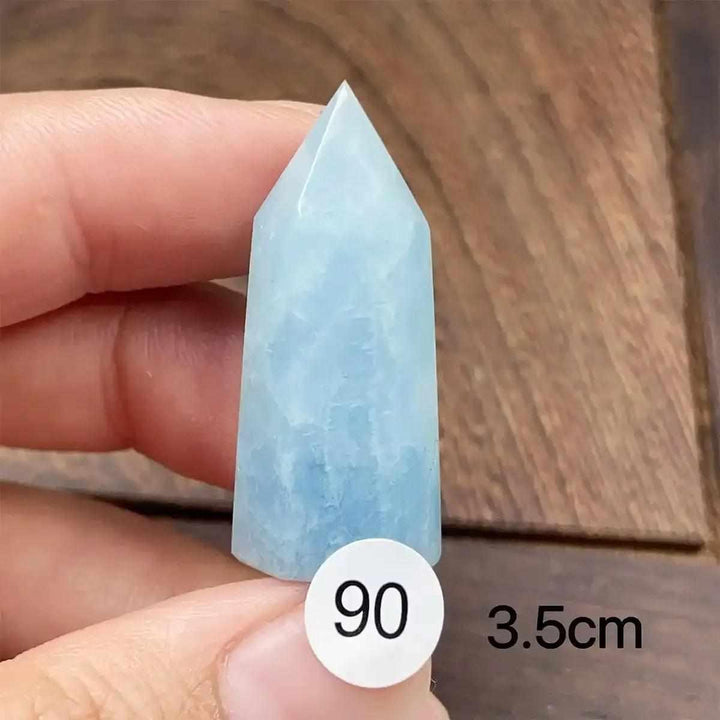 Hand-polished Aquamarine Mini Tower with a faceted point, showcasing a calming sea-blue hue for throat chakra healing.