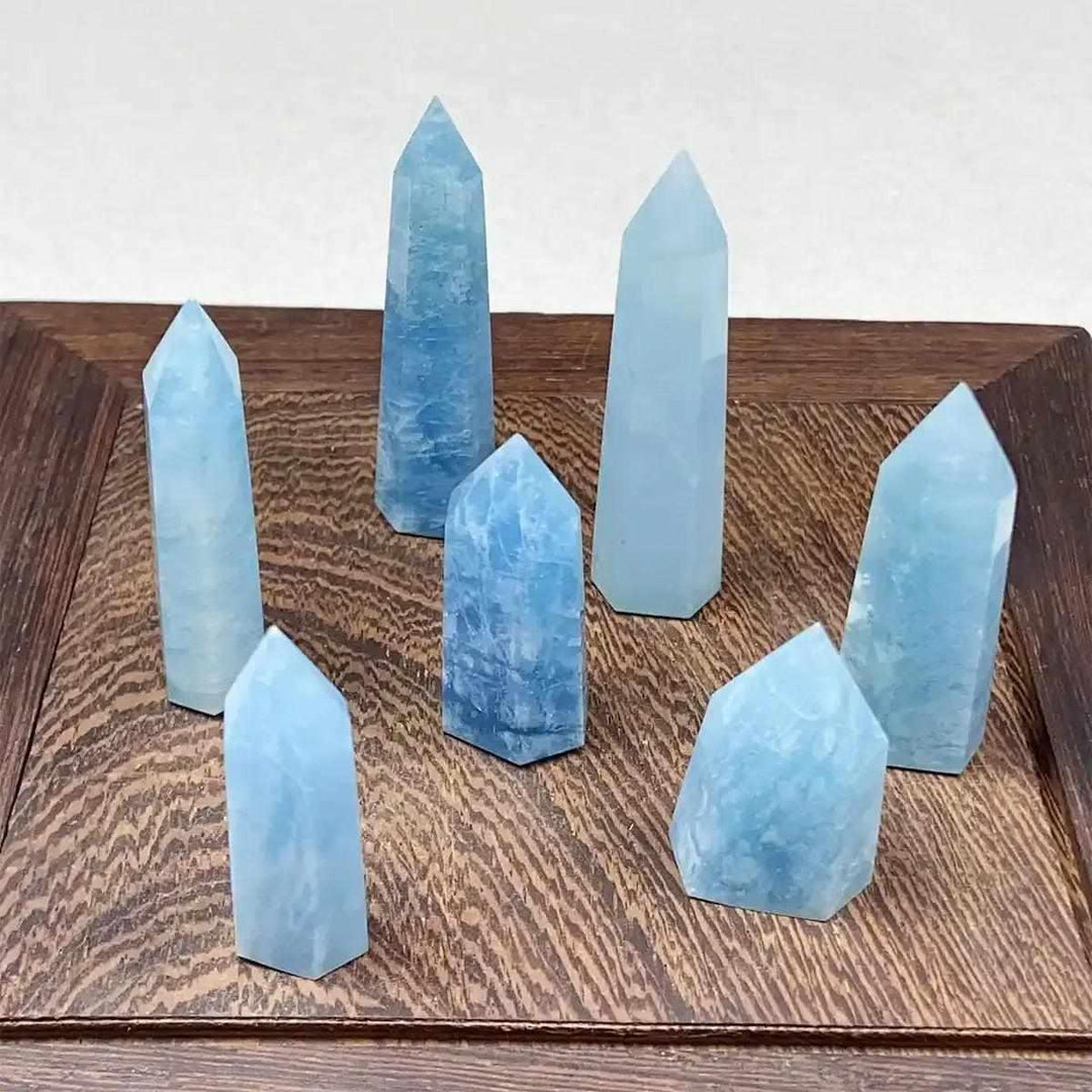 Hand-polished Aquamarine Mini Towers in sea blue hues, featuring faceted points for calm, clear energy and meditation.