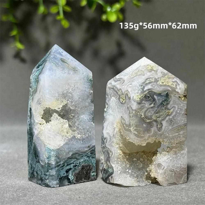 Two Aquatic Agate crystal towers featuring sparkling quartz caves, flowing patterns, and calming Throat Chakra energy.