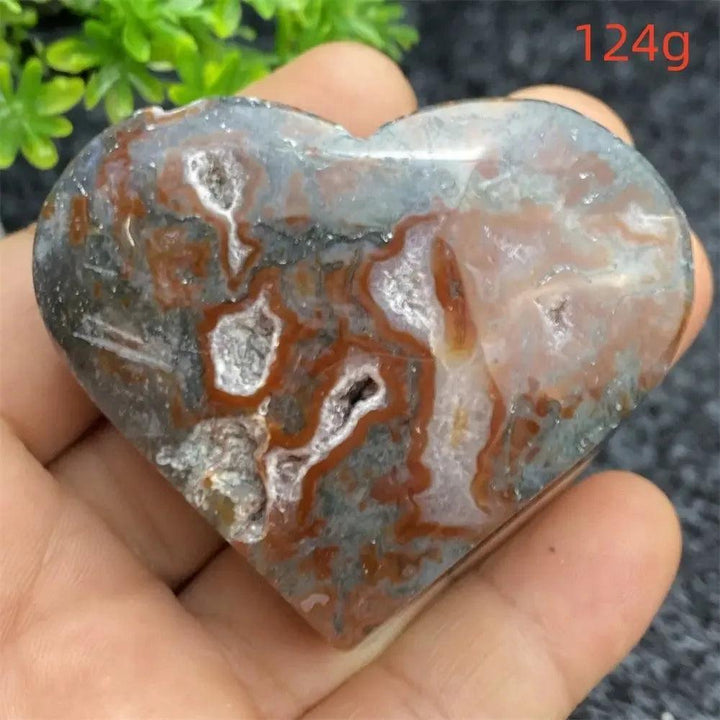 Aquatic Agate Geode Heart: Polished, natural crystal heart with red, gray, and white patterns, featuring sparkling druzy cavities.