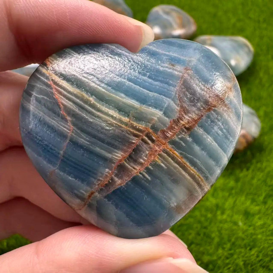 Aquatine Lemurian Blue Calcite Crystal Heart with soothing blue and brown banding for anxiety relief.