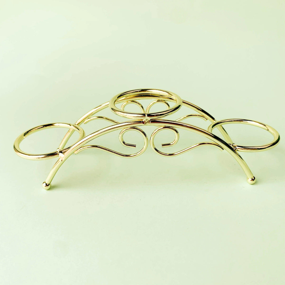 Golden arch crystal display stand with three sphere holders, elegant metal design.