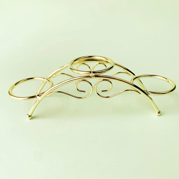 Golden arch crystal display stand with three sphere holders, elegant metal design.