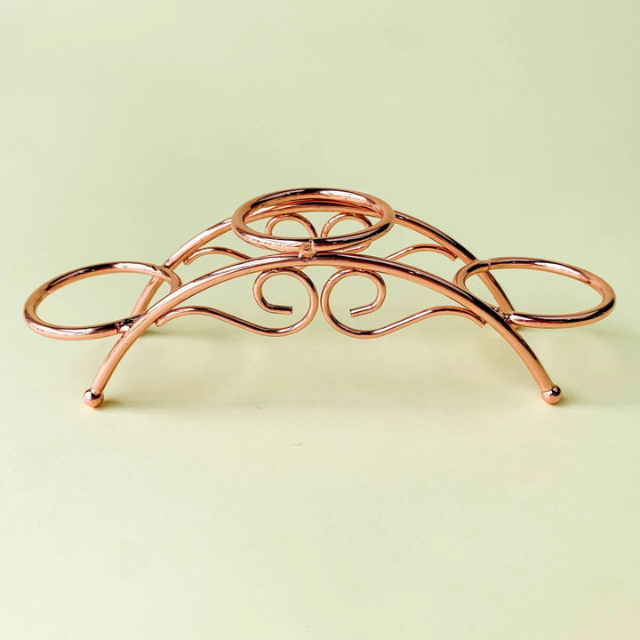 Rose gold arch metal display stand with three sphere holders for crystal spheres or eggs.