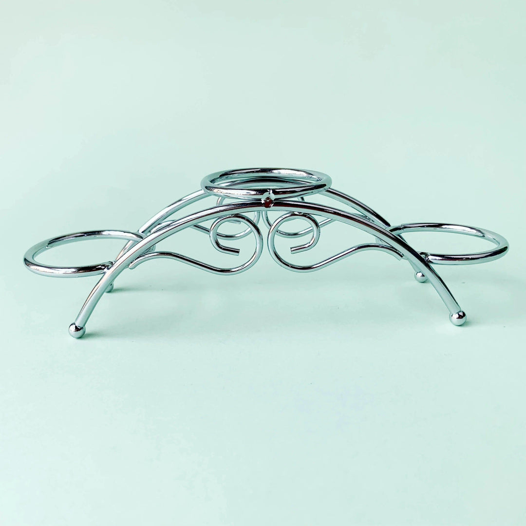 Silvery arch crystal display stand with three sphere holders and elegant scrollwork.