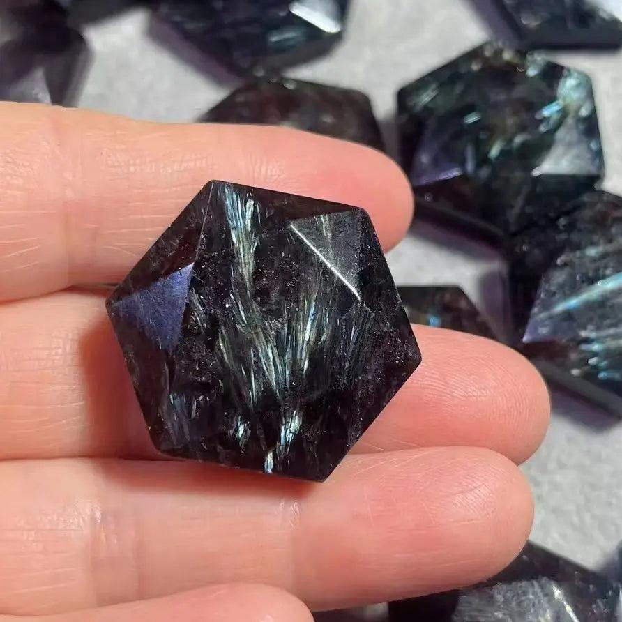 Dark navy Arfvedsonite crystal carved into a six-pointed star, with silver, gold, and blue flashes.