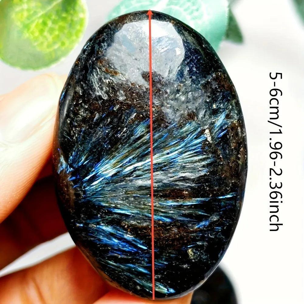 Polished Astrophyllite palm stone with stunning blue starburst inclusions, perfect for healing, meditation, and energy work.