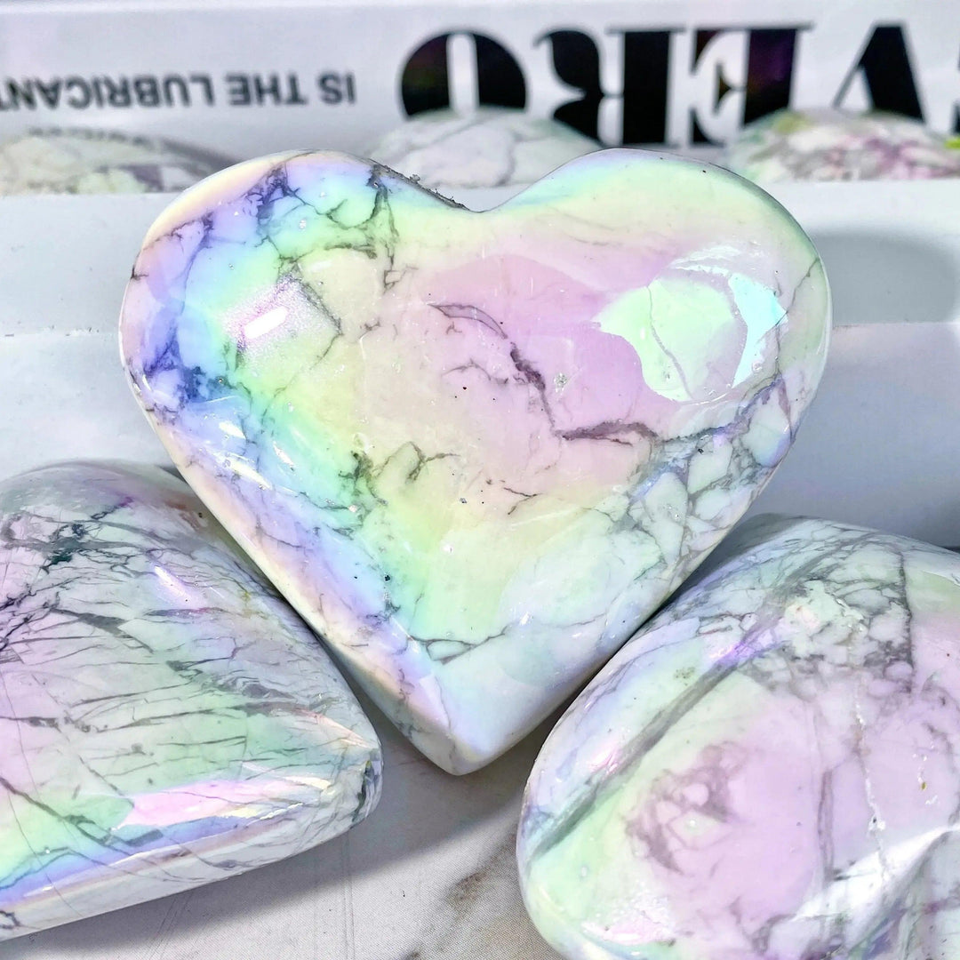 Iridescent Aura Howlite crystal heart from Crystal Destiny, showcasing calming white with rainbow flashes.