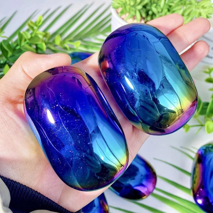 Polished Aura Obsidian palm stone with iridescent blue and violet shimmer for grounding and root chakra healing.