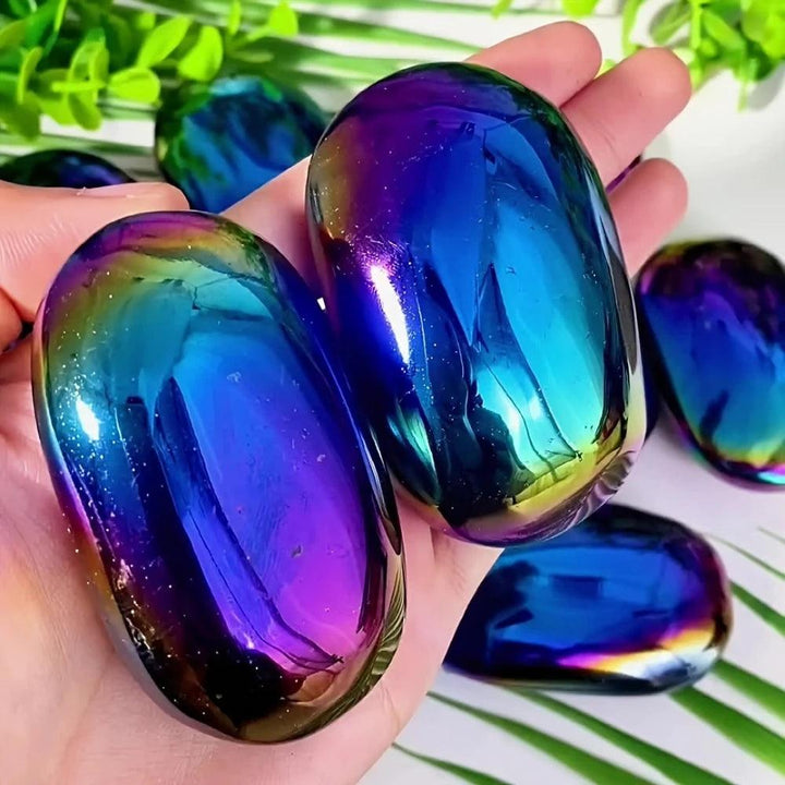 Polished Aura Obsidian palm stone with iridescent blue and violet shimmer for grounding and spiritual transformation.